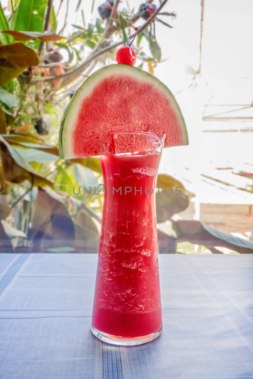 Fresh watermelon smoothie in a glass on the table