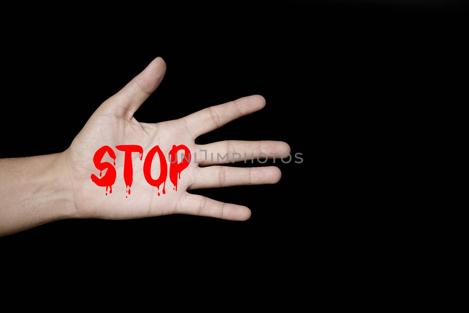 A woman holding a conceptual stop sign on violence against women. Womens day and Human Rights Day concept.