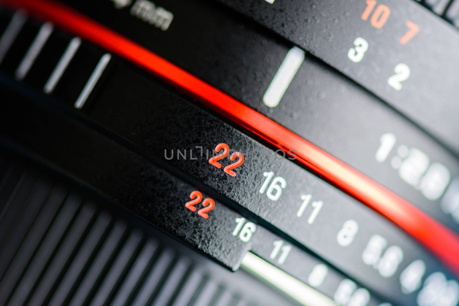 Macro shot of a camera lens focusing on camera lens information. by spukkato