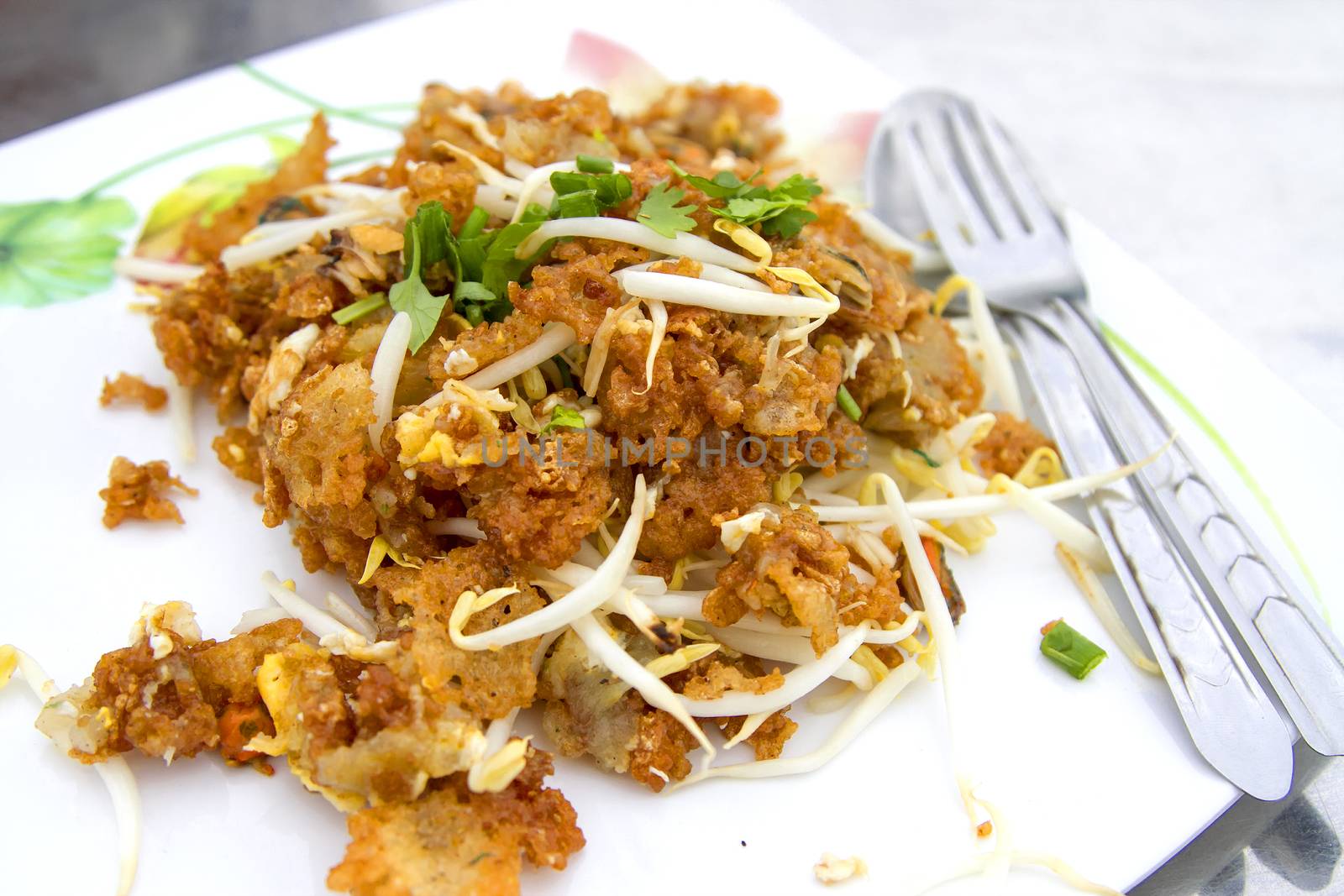Oysters fried in egg batter in a white dish with spoon and mug by TakerWalker
