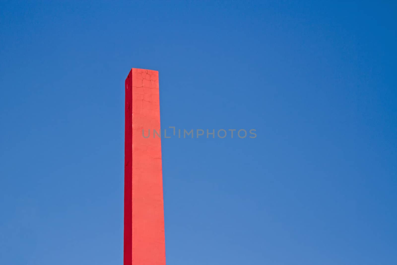 Pink rectangular chimney with blue sky