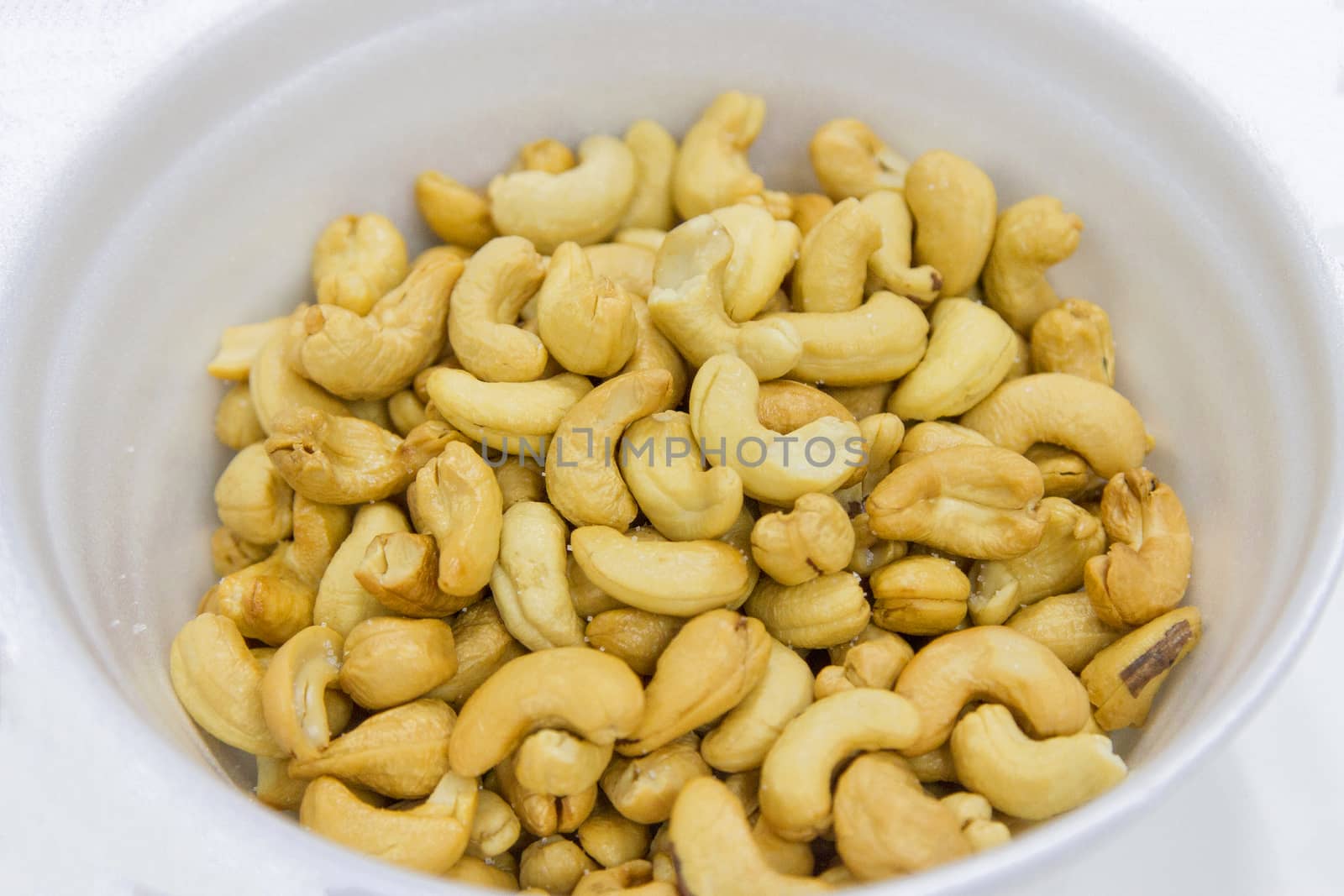 Cashews In a white container by TakerWalker
