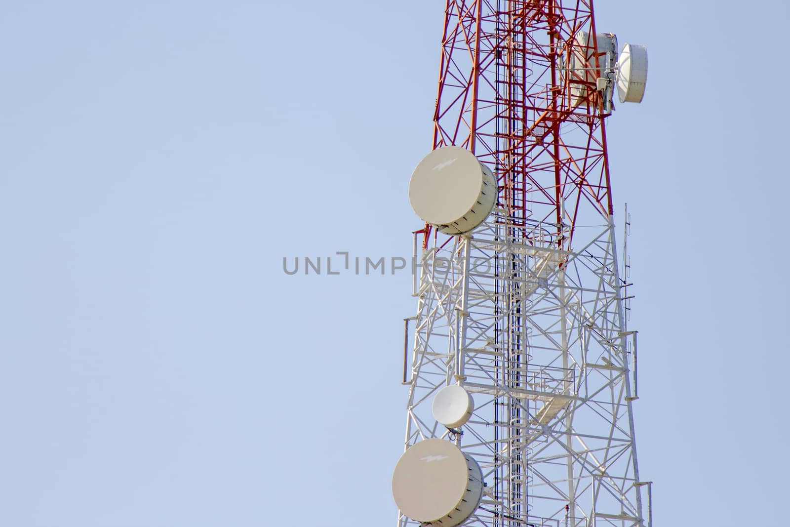 Mobile phone communication tower transmission with blue sky back by TakerWalker