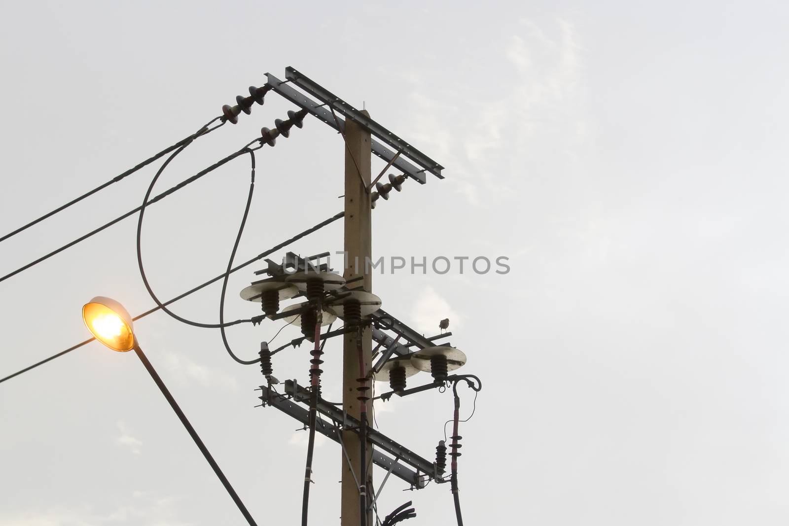 Power poles with lights in the evening. by TakerWalker