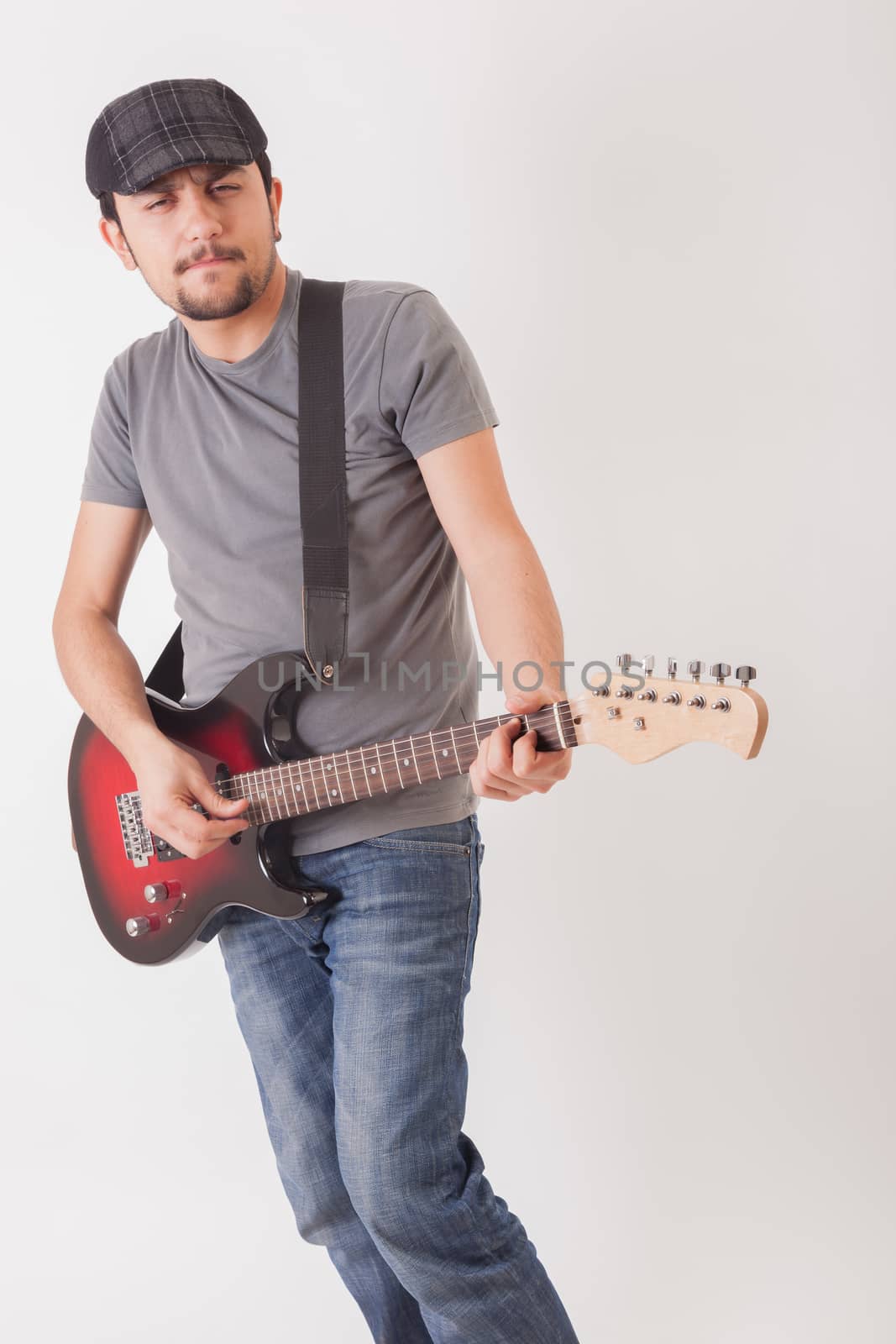 young man jumping with electric guitar on white background