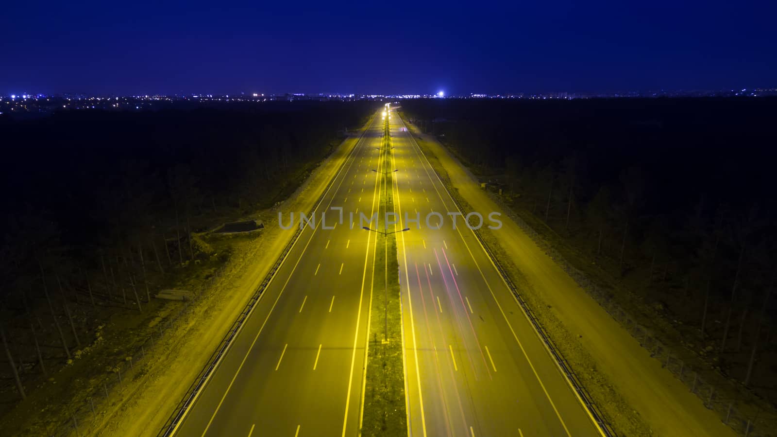 Aerial, vertical - Traffic at night. Roundabout over highway