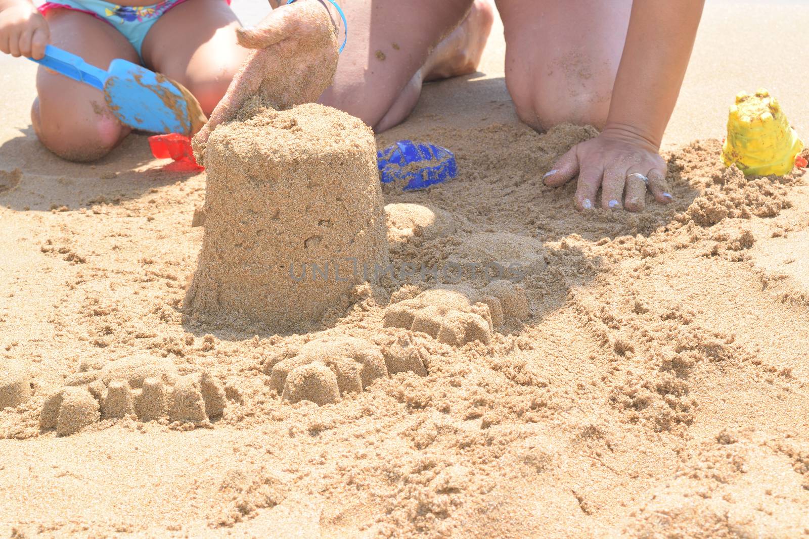 building a sand castle on the beach