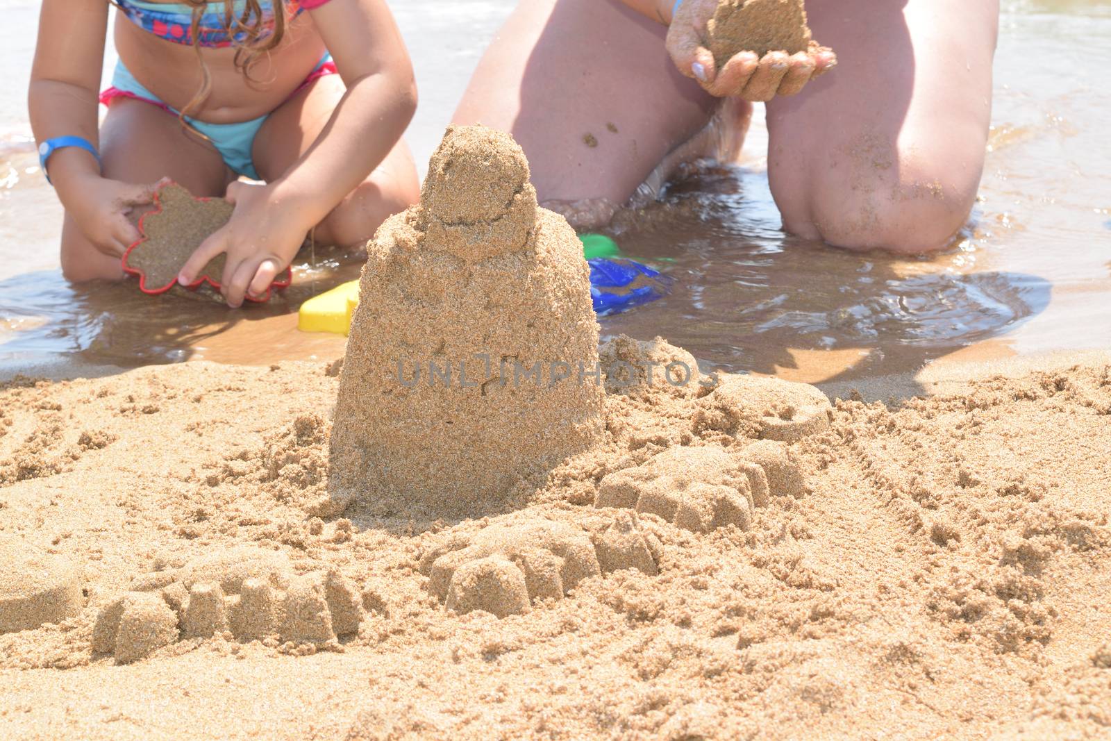 building a sand castle on the beach