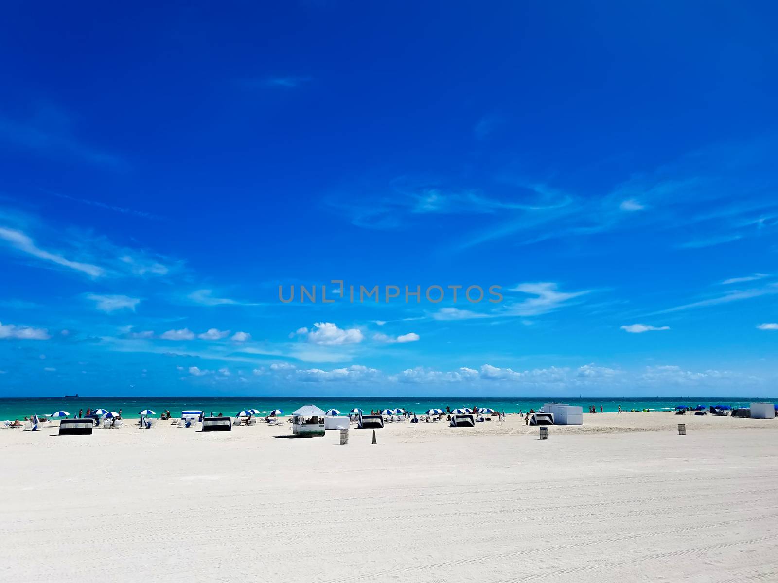 Beach in South Beach, Florida, a city near Miami, with white sand and blue sky, on a suuny day.