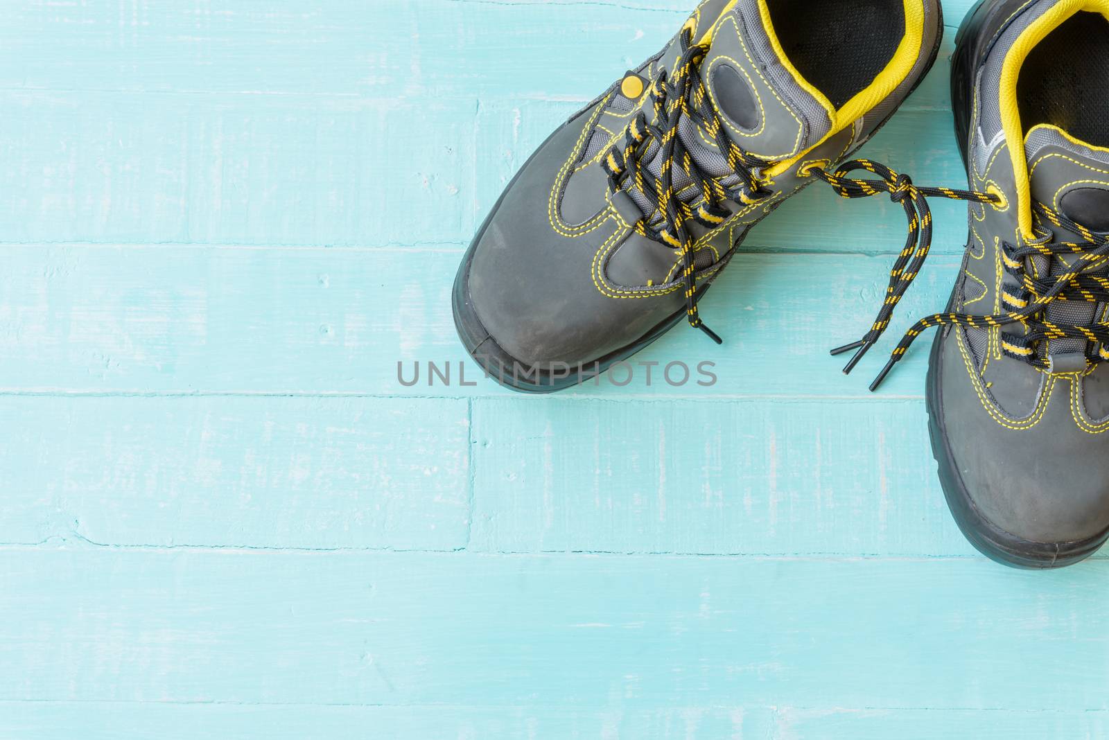 April fool's day concept. shoelaces tied together and Wooden block calendar with empty space for text on bright blue and white wooden background.