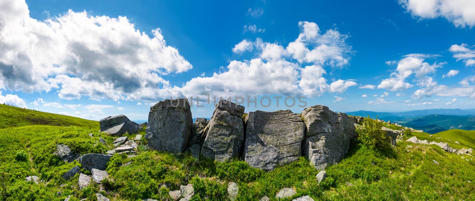 mountainous panorama with boulders on hillside. beautiful summer landscape in fine weather under the lovely cloudscape