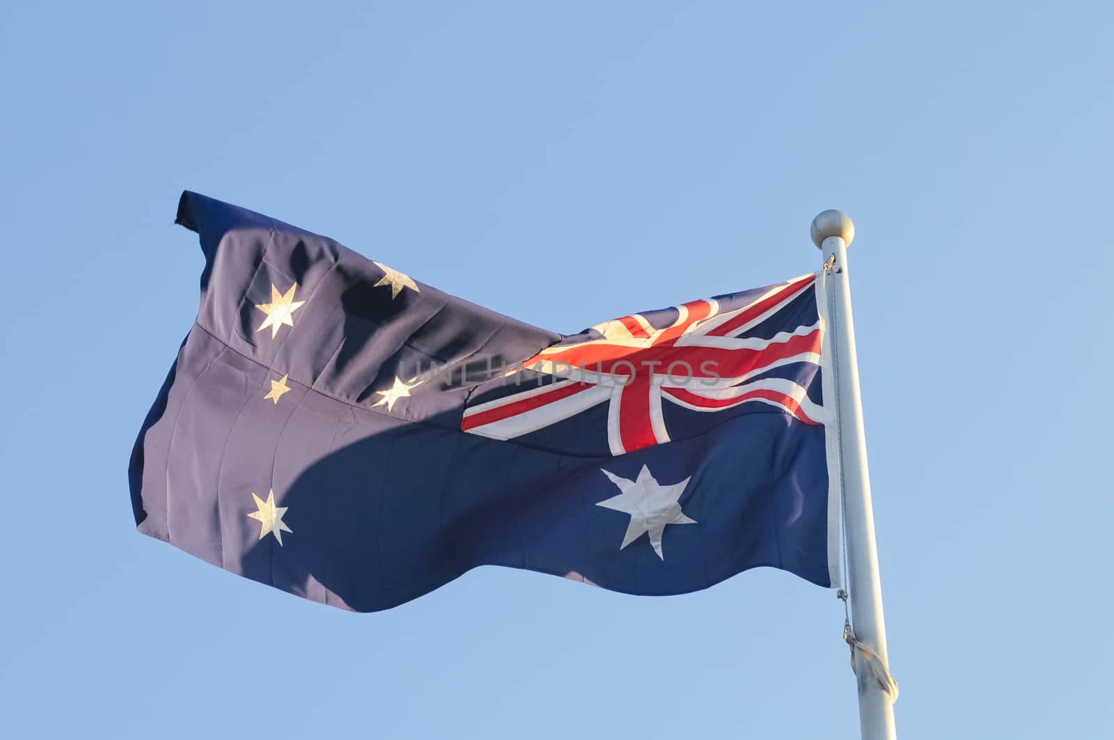 Waving Australia National Flag in windy day by eyeofpaul