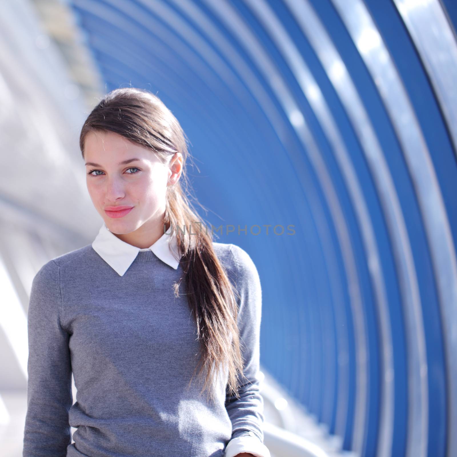 Young Businesswoman standing in corridor of modern office building