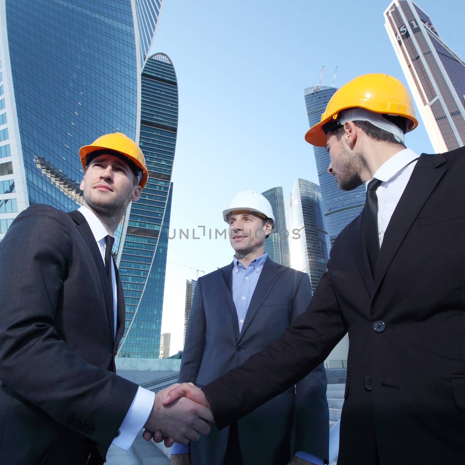 Investor and contractor shaking hands by ALotOfPeople