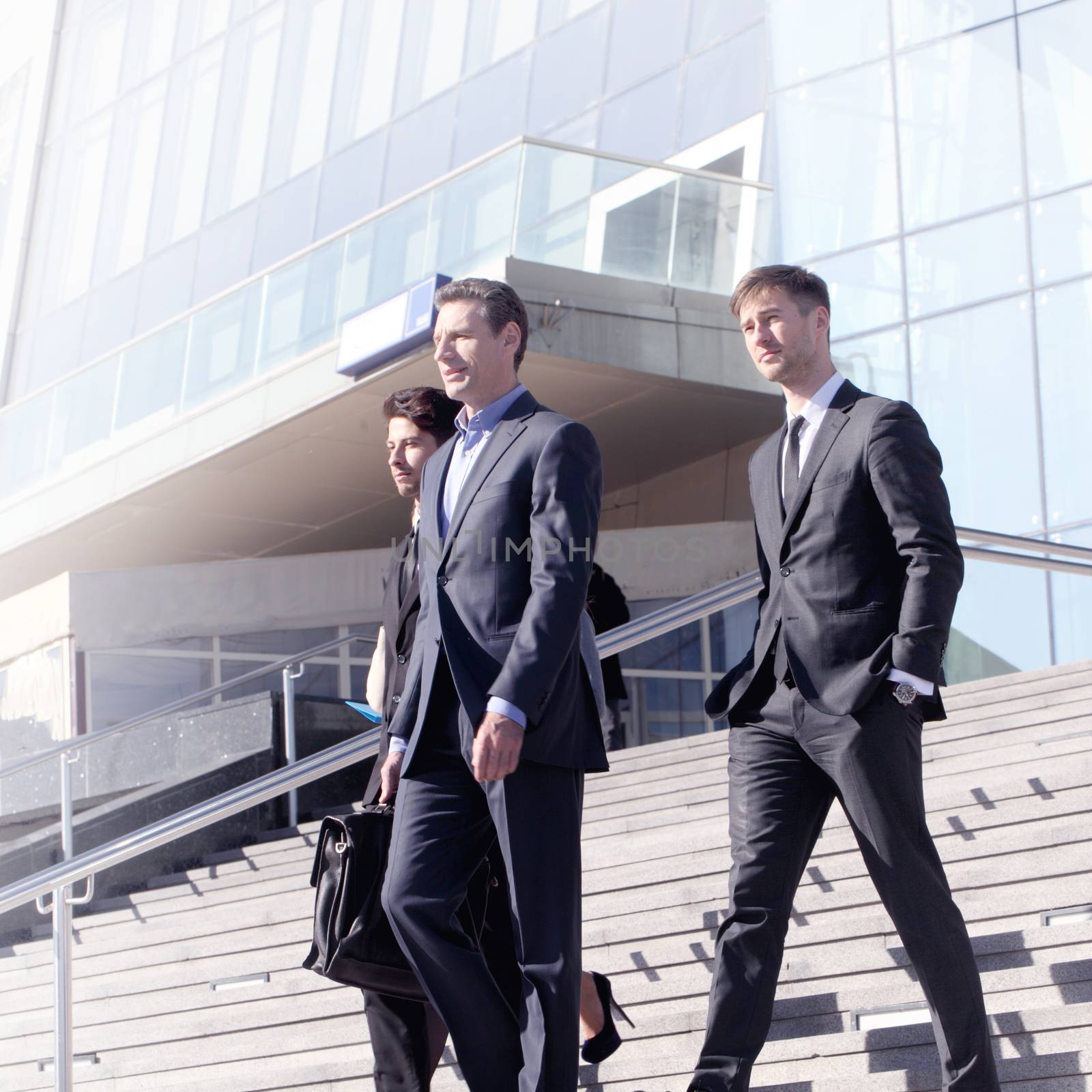 Team of diverse business people at stairs of company office building