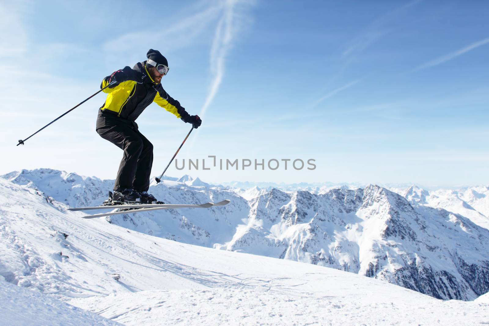 Jumping skier at mountains by destillat