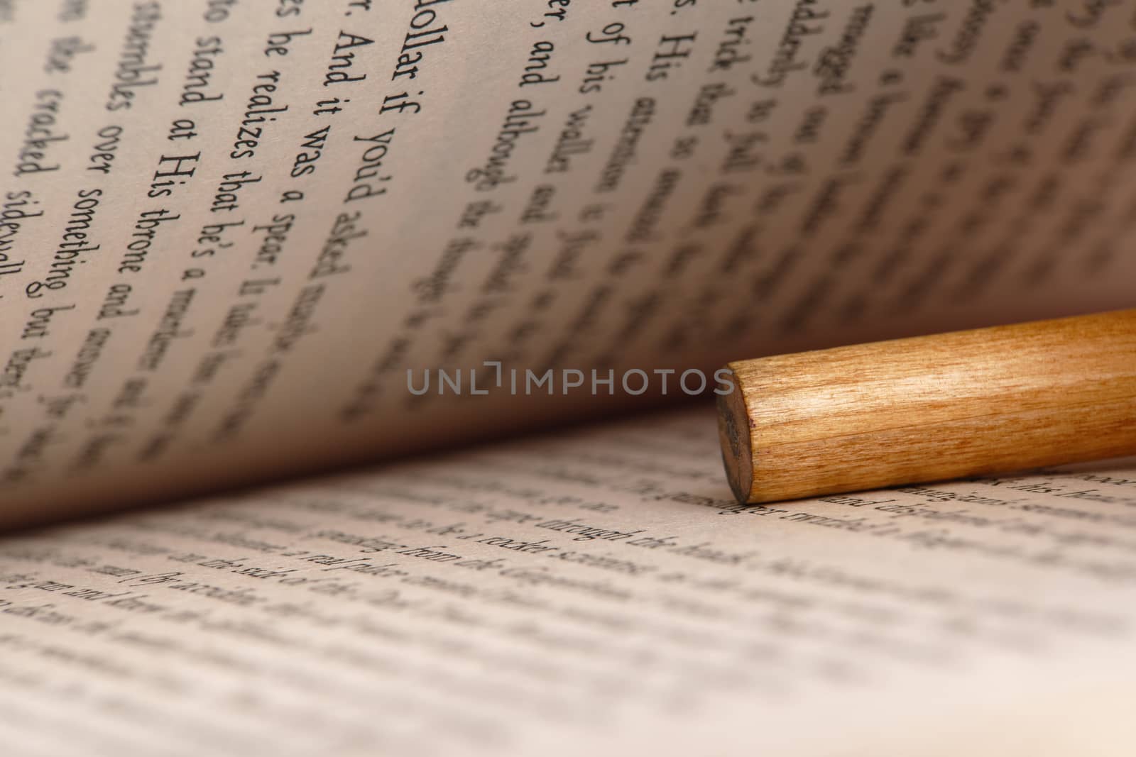 close-up of an open book with a pencil inside
