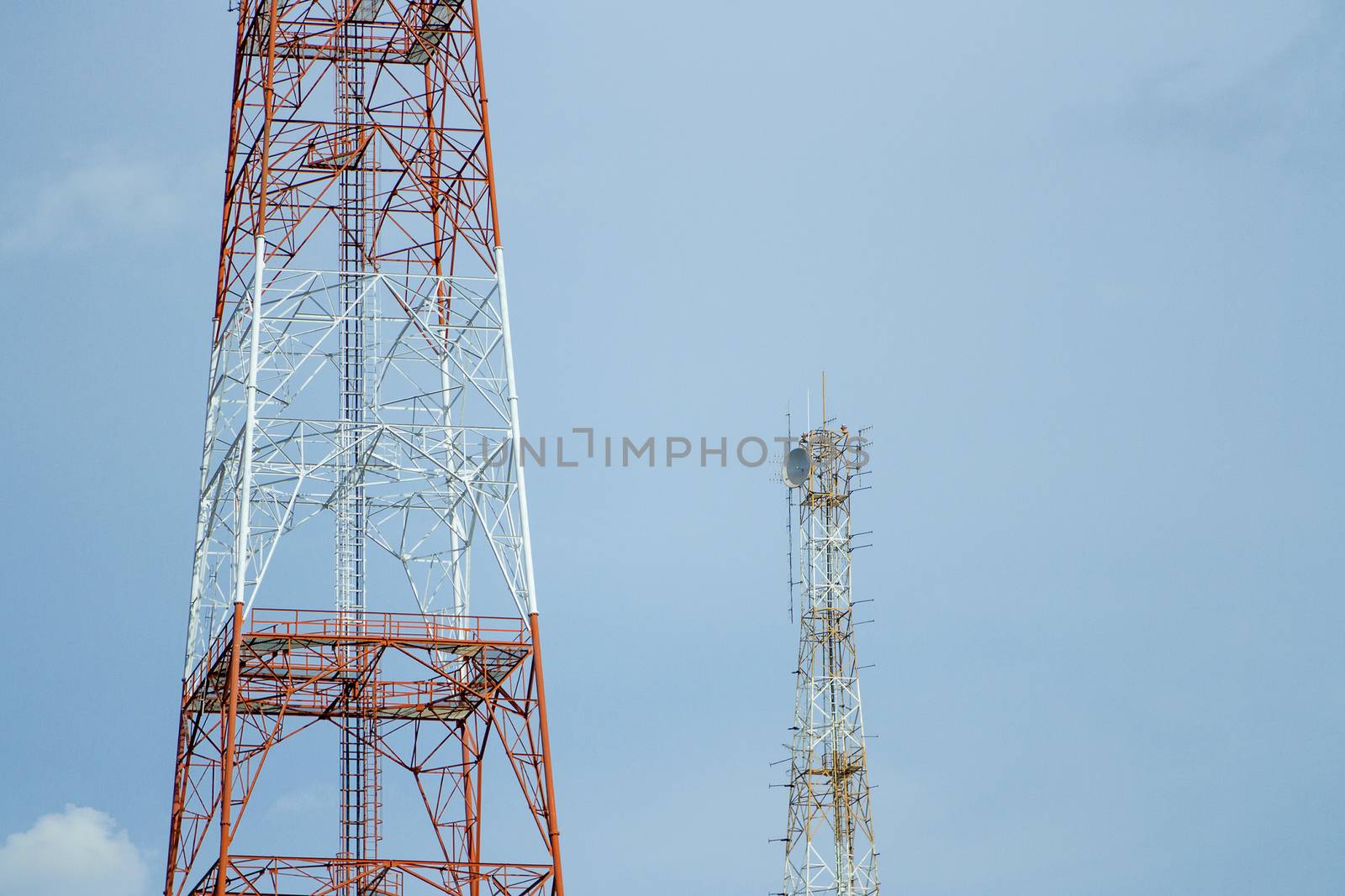 Two signal tower with blue sky. by TakerWalker