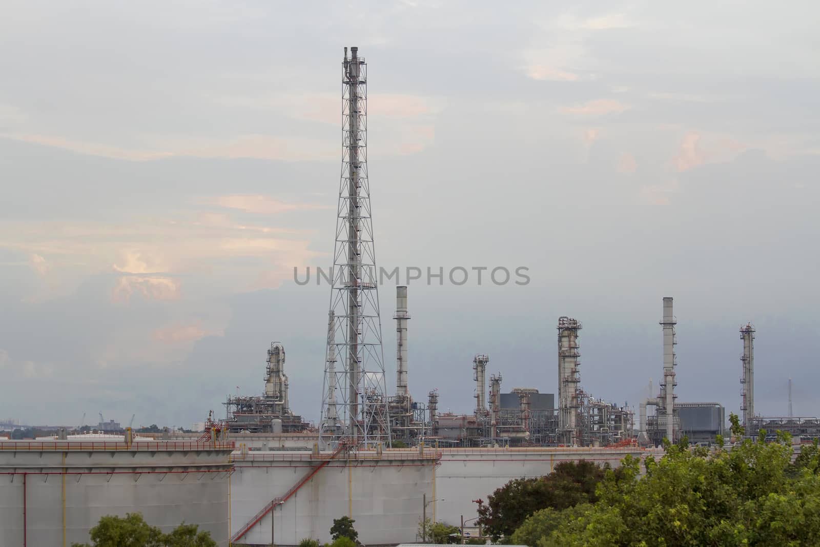 Oil refinery with evening sky.