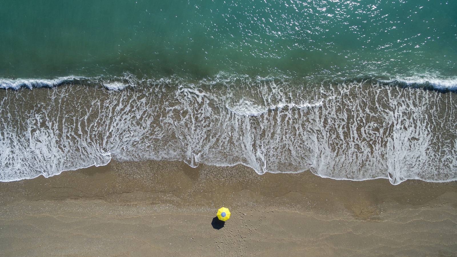 AERIAL: sunbathing on beach. No people only umbrella Antalya