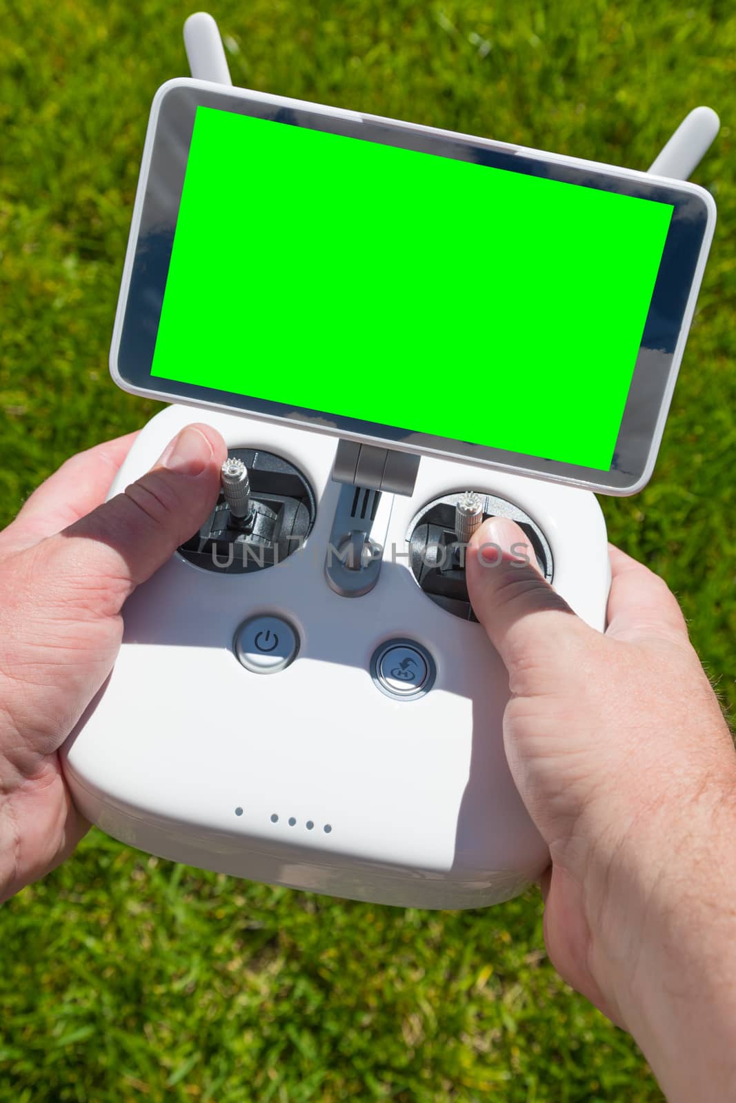 Hands Holding Drone Quadcopter Controller With Blank Green Screen by Feverpitched