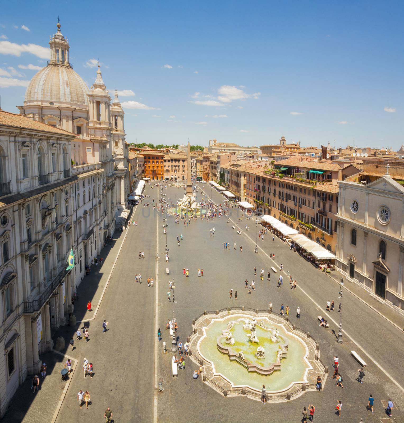 view of the famous Piazza Navona in Rome in a sunny day with tourists walking. Baroque architecture. Travel and tourism