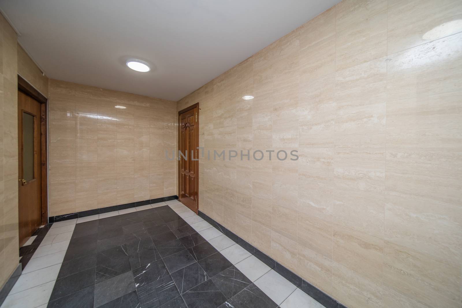empty entrance in luxury apartment building tile beige color