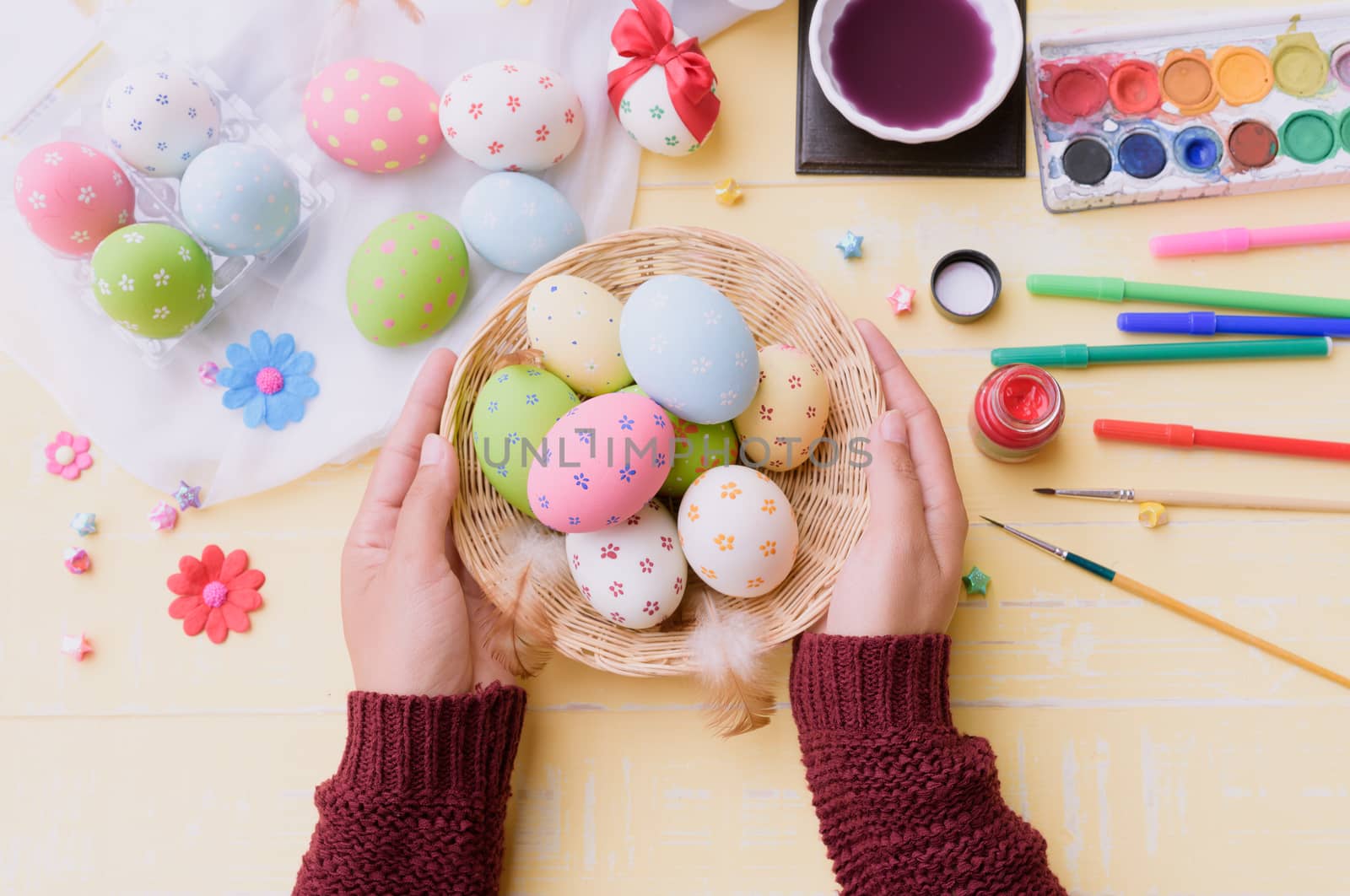 Happy easter! A woman hand holding for painting Easter eggs. Happy family preparing for Easter.
