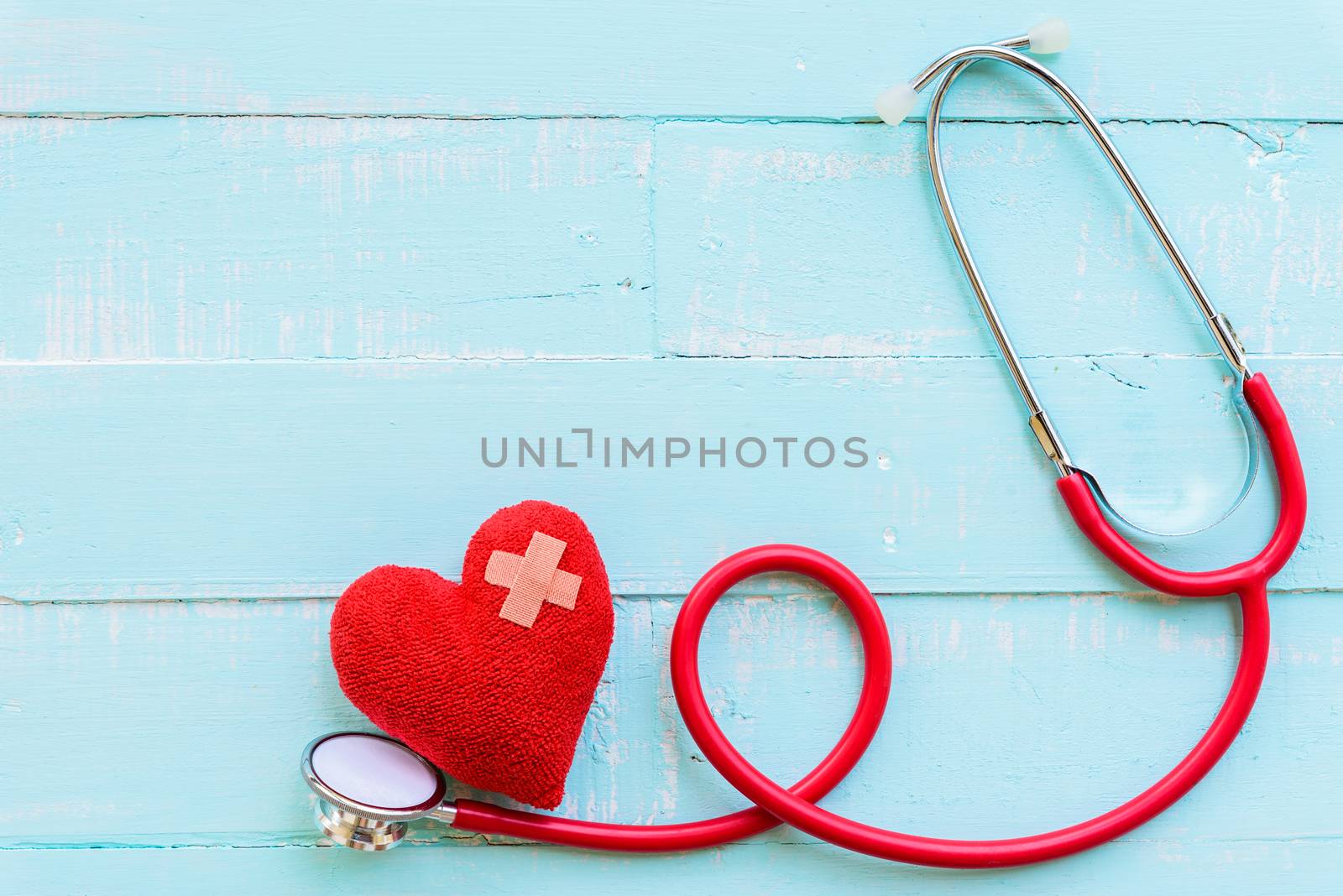 World health day, Healthcare and medical concept. Stethoscope and red heart on Pastel white and blue wooden table background texture.