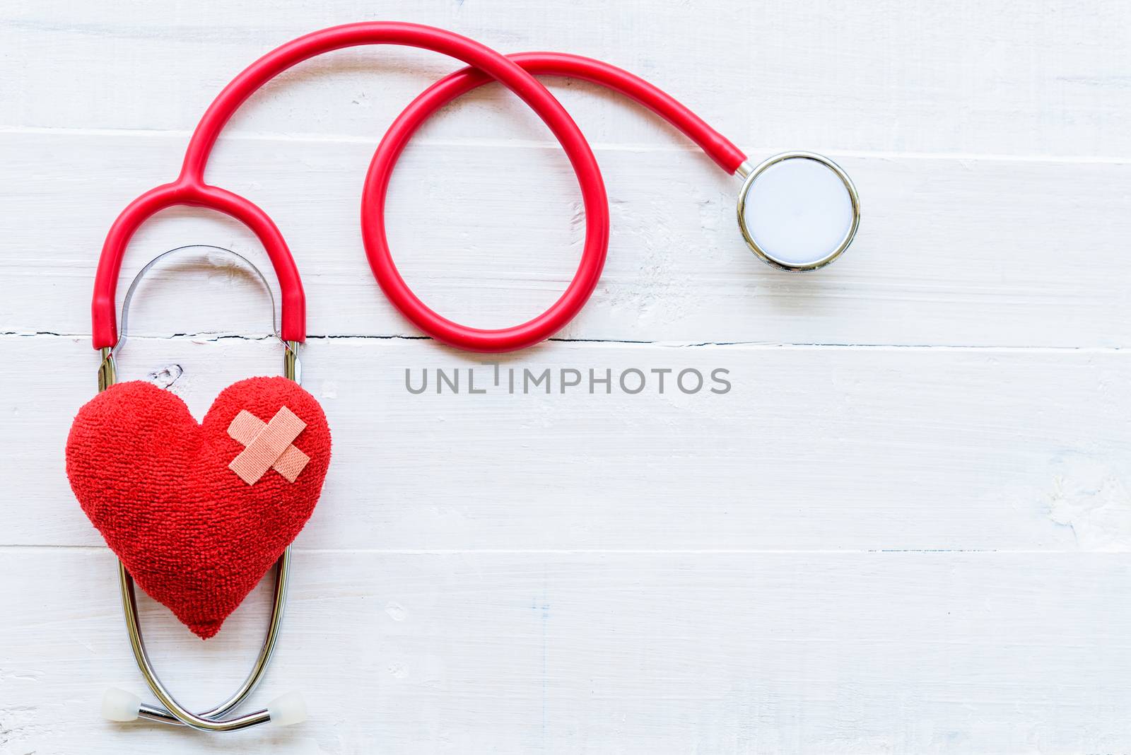 World health day, Healthcare and medical concept. Stethoscope, red heart, notepad or notebook, thermometer and yellow Pill on Pastel white and blue wooden table background texture.