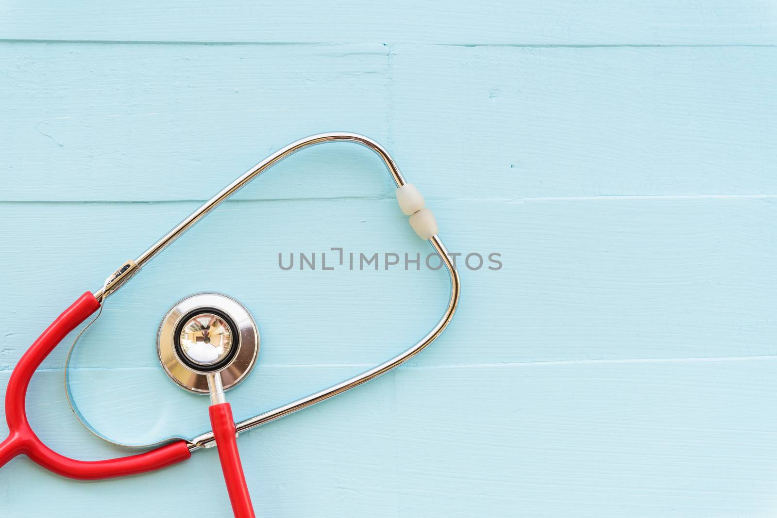 World health day, Healthcare and medical concept. Red heart with Stethoscope, notepad or notebook, thermometer and yellow Pill on Pastel white and blue wooden table background texture.