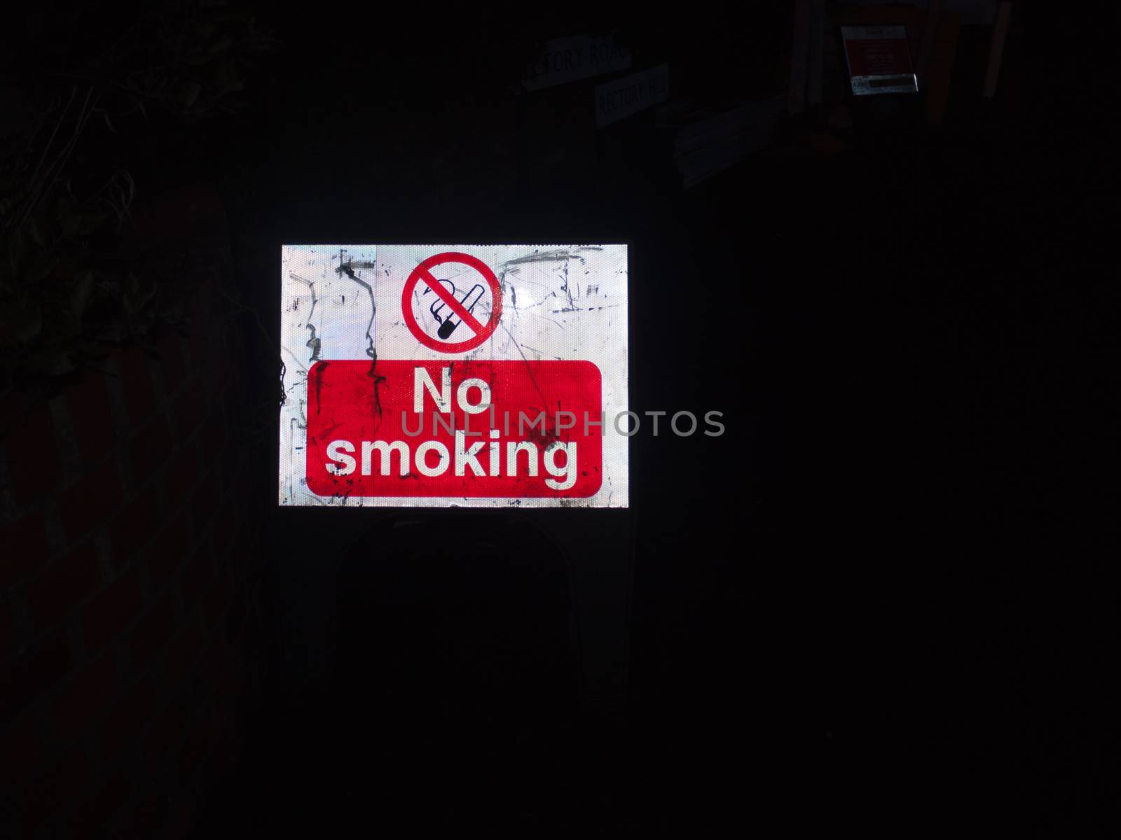 street sign construction night time no smoking red and white; essex; england; uk