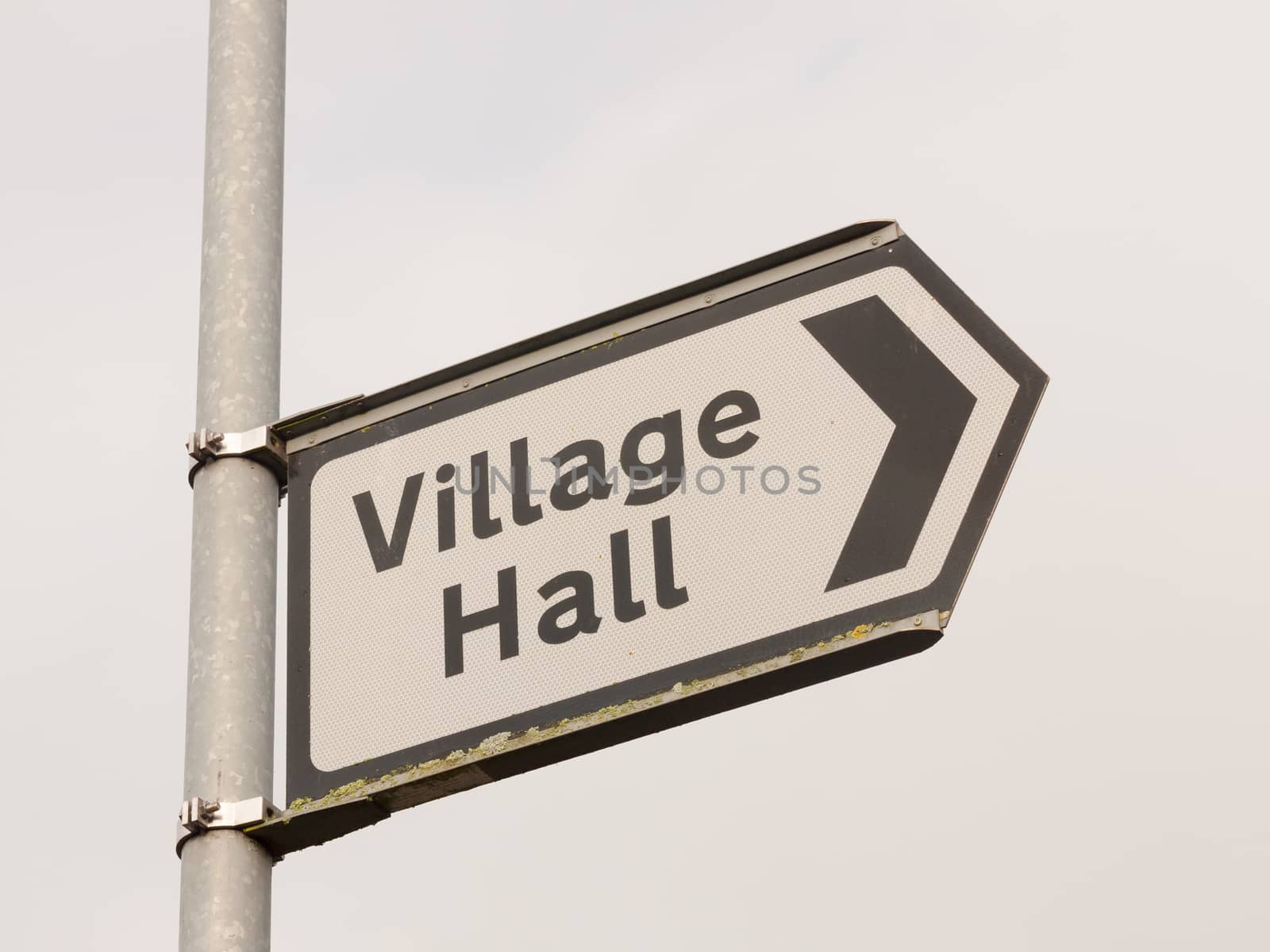 white and black village hall sign post direction street; essex; england; uk