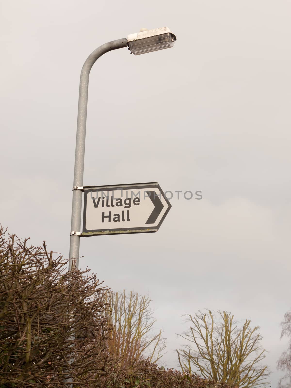 white and black village hall sign post direction street; essex; england; uk