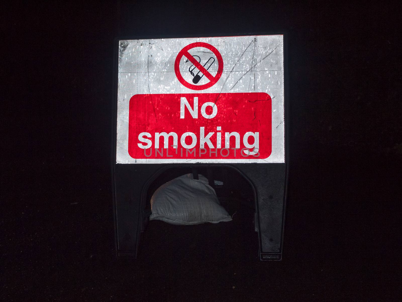 street sign construction night time no smoking red and white; essex; england; uk