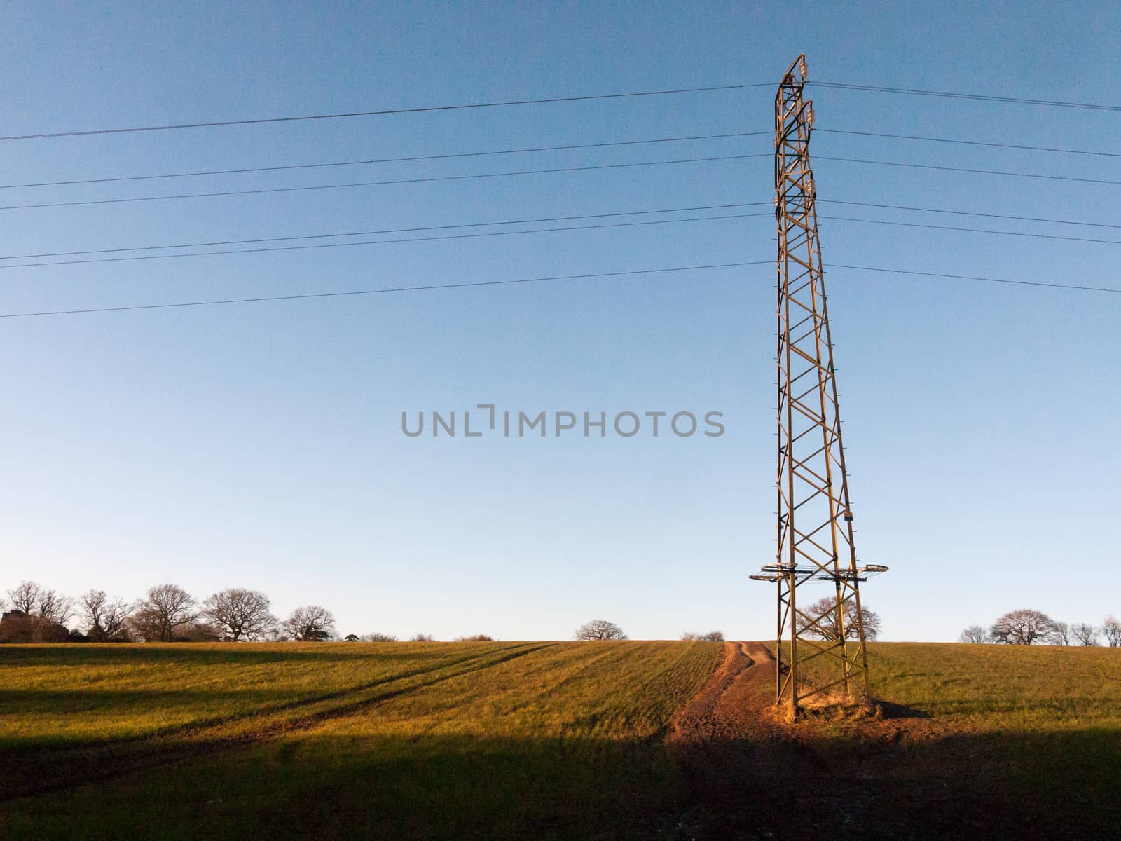 large metal tower field farm blue sky electric pylon communicati by callumrc