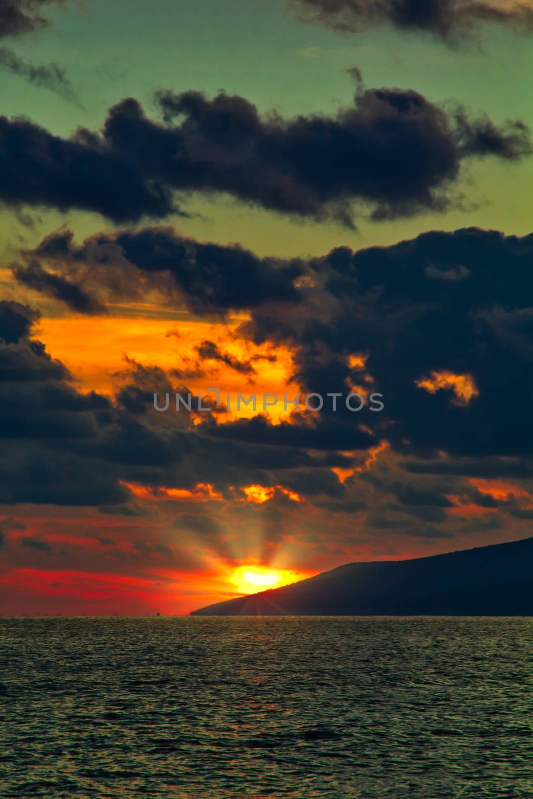 Nature in twilight period which including of sunrise over the sea and the nice beach. Summer beach with blue water and purple sky at the sunset.