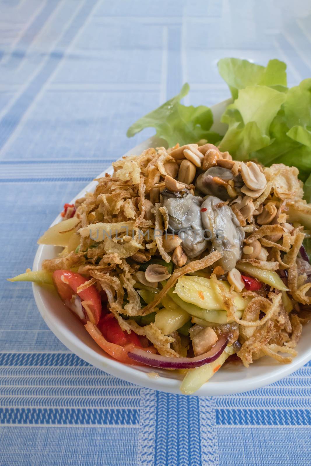 spicy yellow mango salad with fresh oyster , shallot garnish and crispy shallot