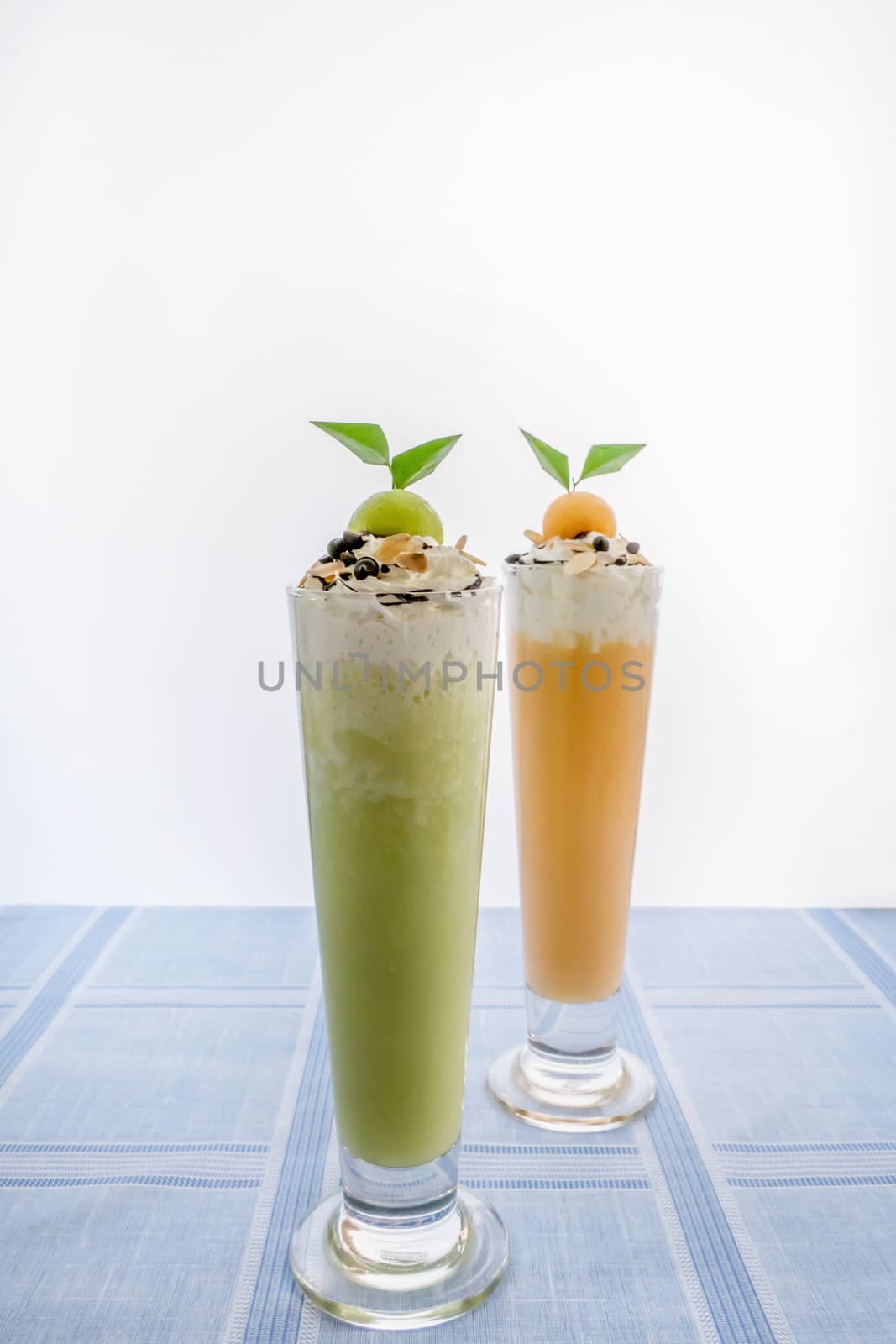 Fresh melon smoothie in a glass on the table