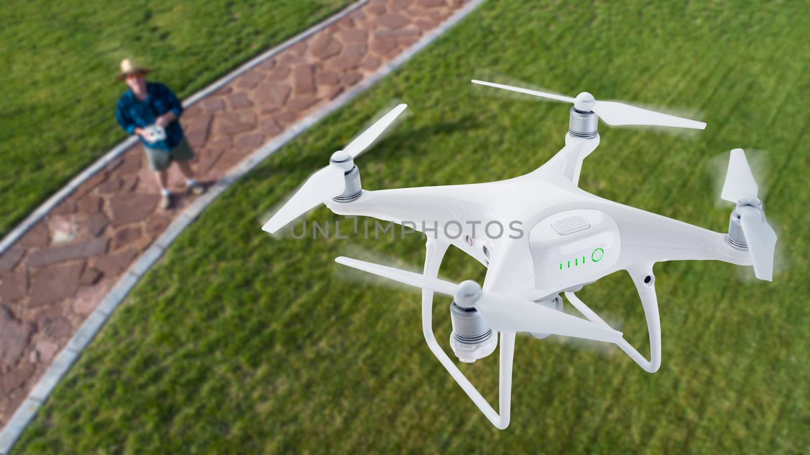 Drone Quadcopter (UAV) In Air Above Pilot With Remote Controller.