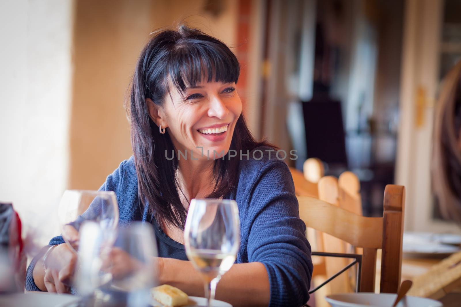 Pretty Italian Woman Enjoys A Meal And Drinks with Friends at Outdoor Restaurant. by Feverpitched
