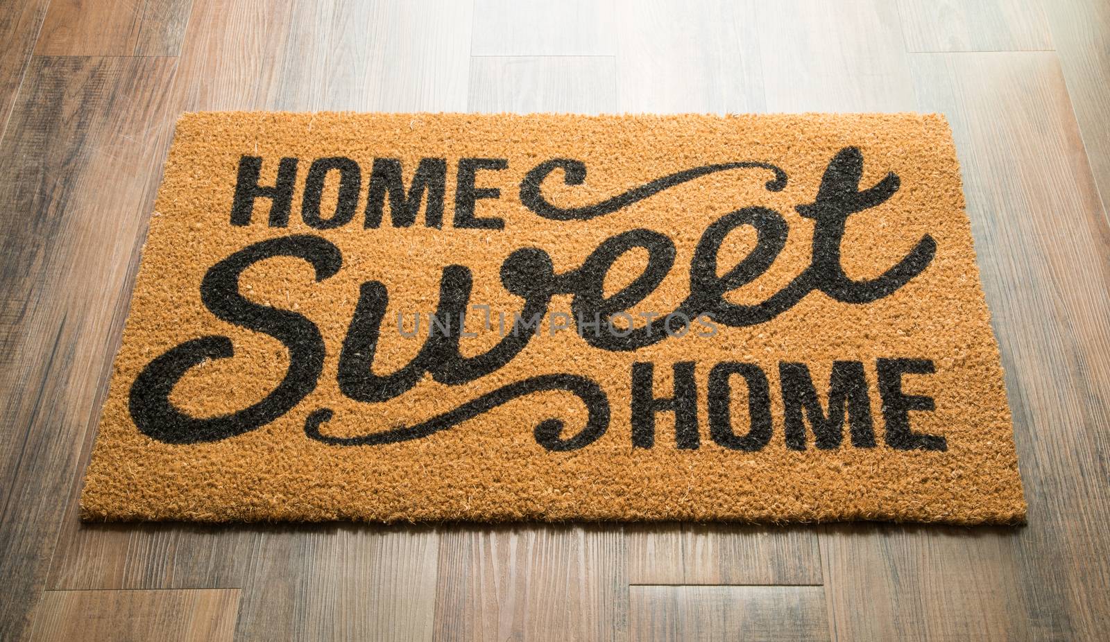 Home Sweet Home Welcome Mat On Wood Floor.