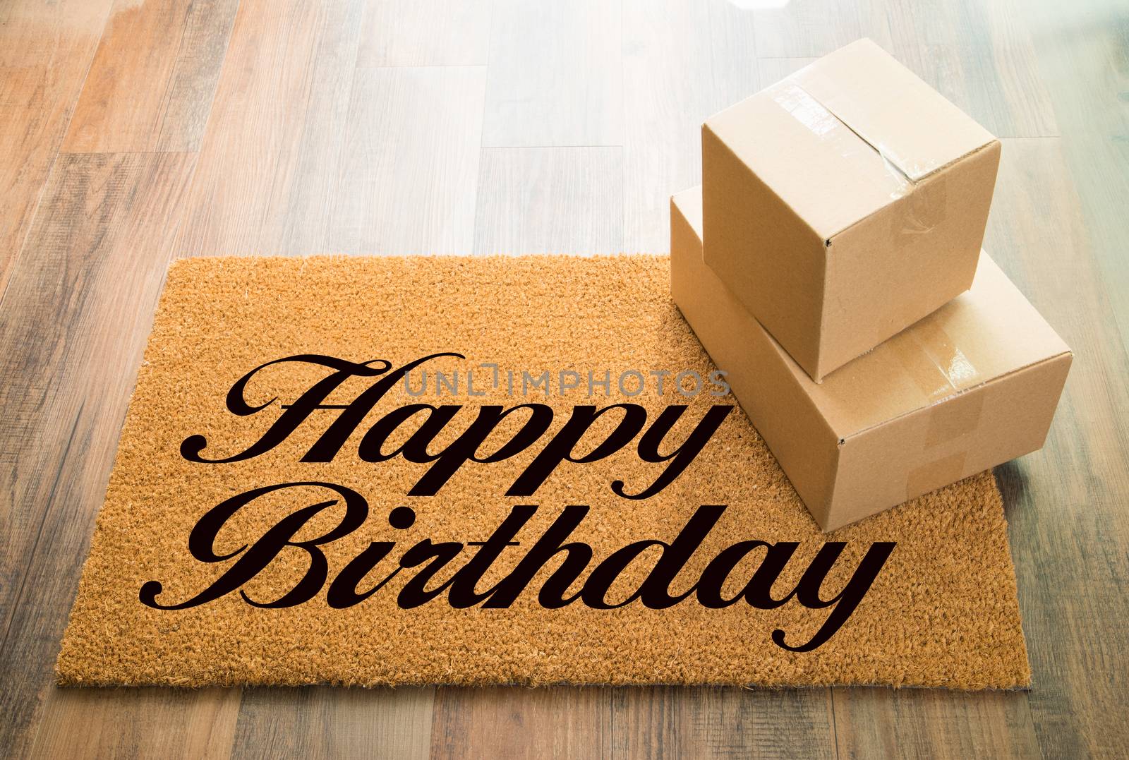 Happy Birthday Welcome Mat On Wood Floor With Shipment of Boxes by Feverpitched