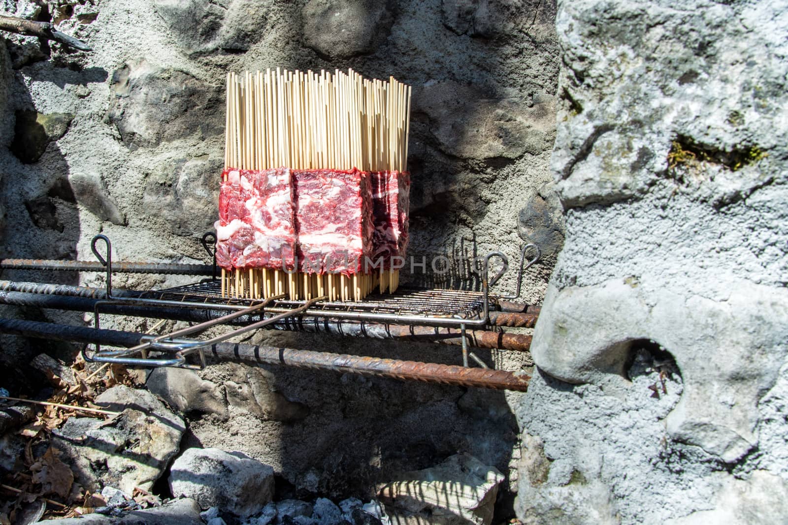 Arrosticini on the grill vertical cooking, Abruzzi skewers of sheep.