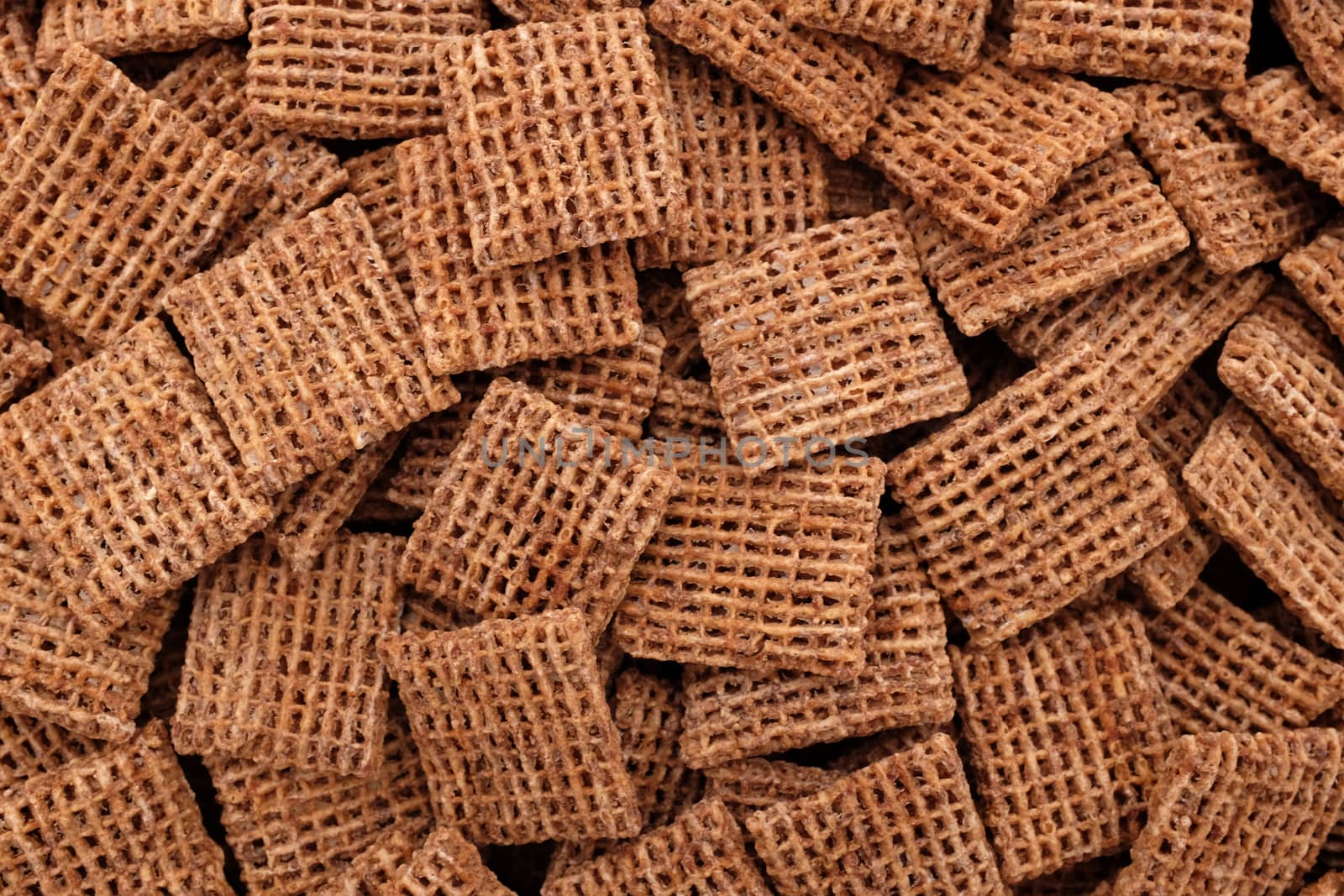 Malted wheat biscuits breakfast cereal as an abstract background texture - close detail