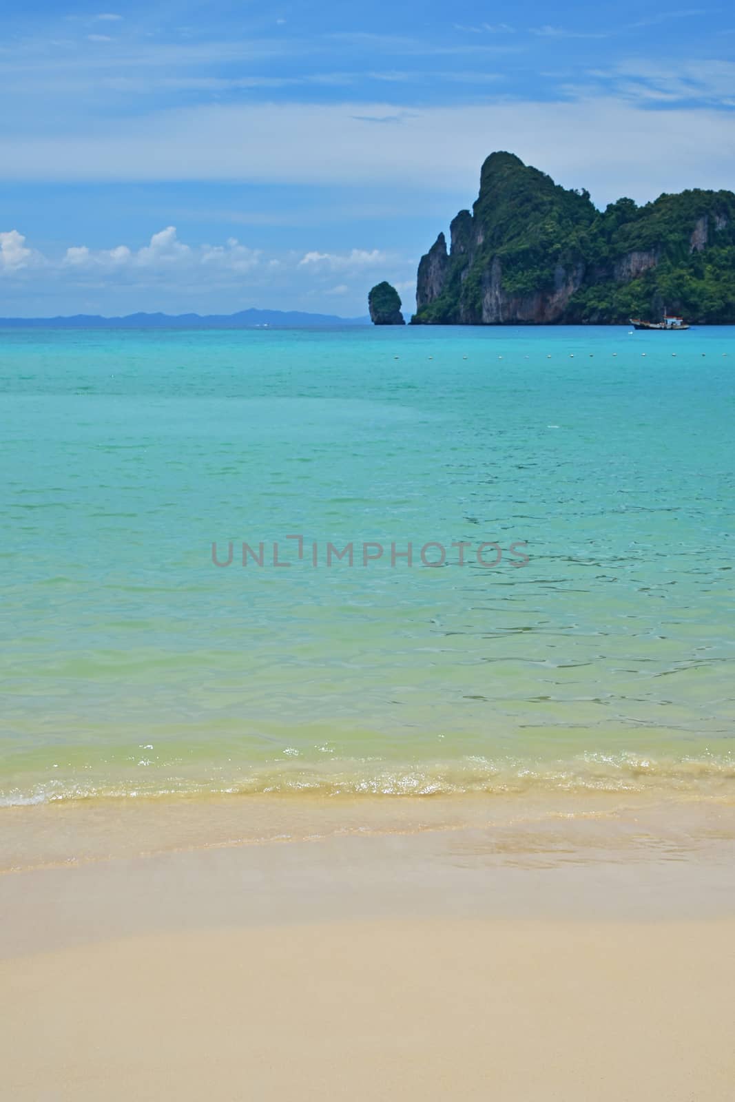 Tranquil seascape of tropical island sand beach, turquoise blue sea water and cloudy sky with horizon, summer day, low angle view