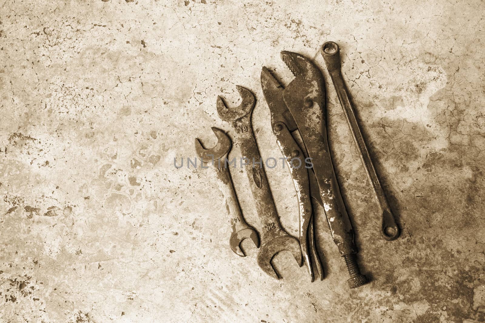 The old rusty tools supplies put on the ground sepia style