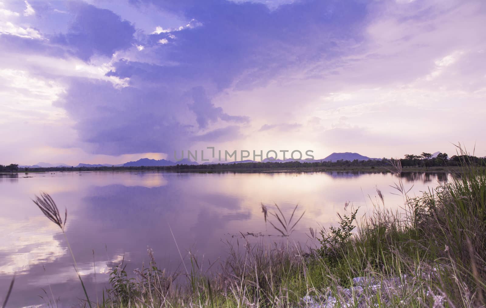 Lake summer view with reflection of clouds on water surface