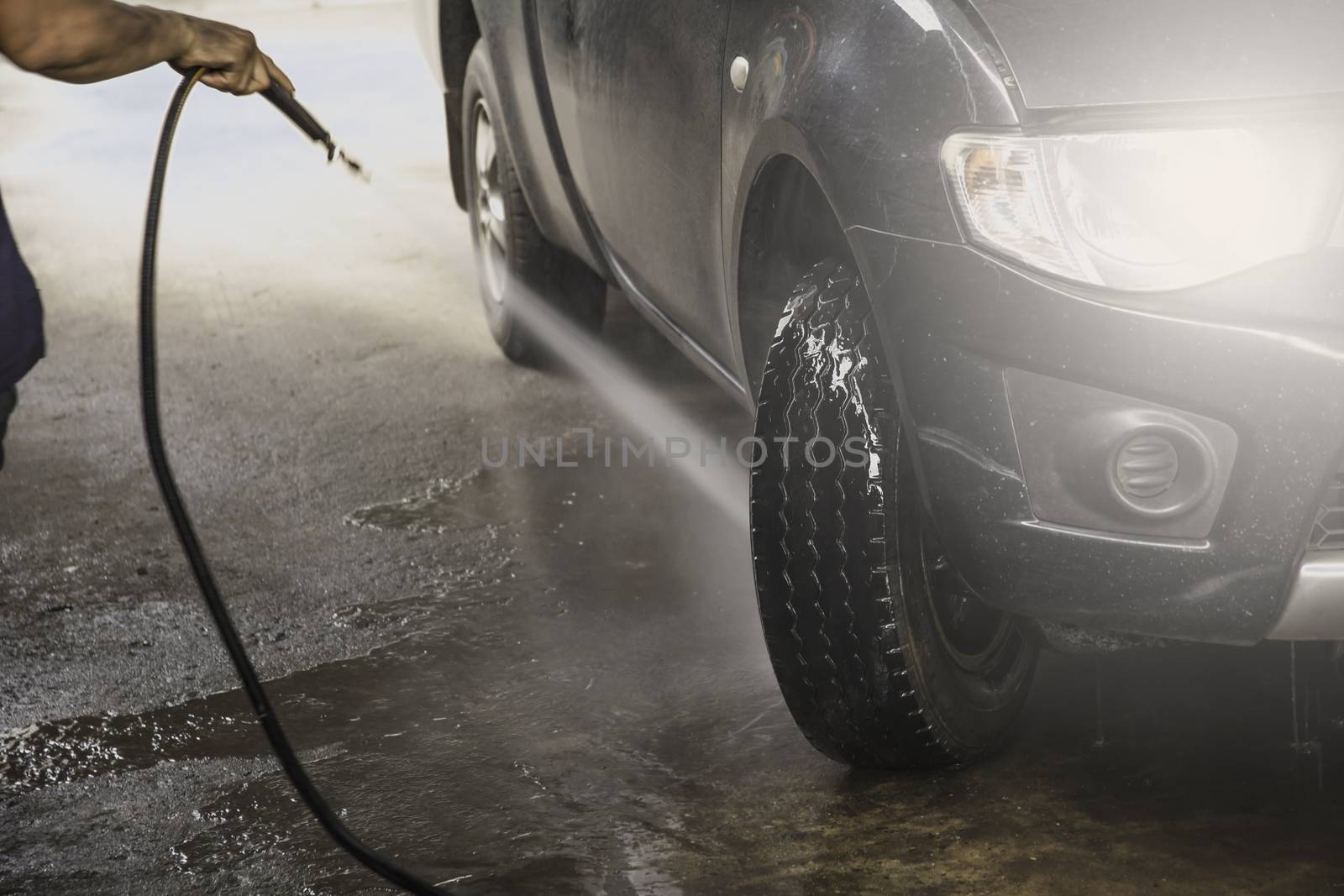 Washing black car by high pressure water. Car wash closeup.  by kirisa99