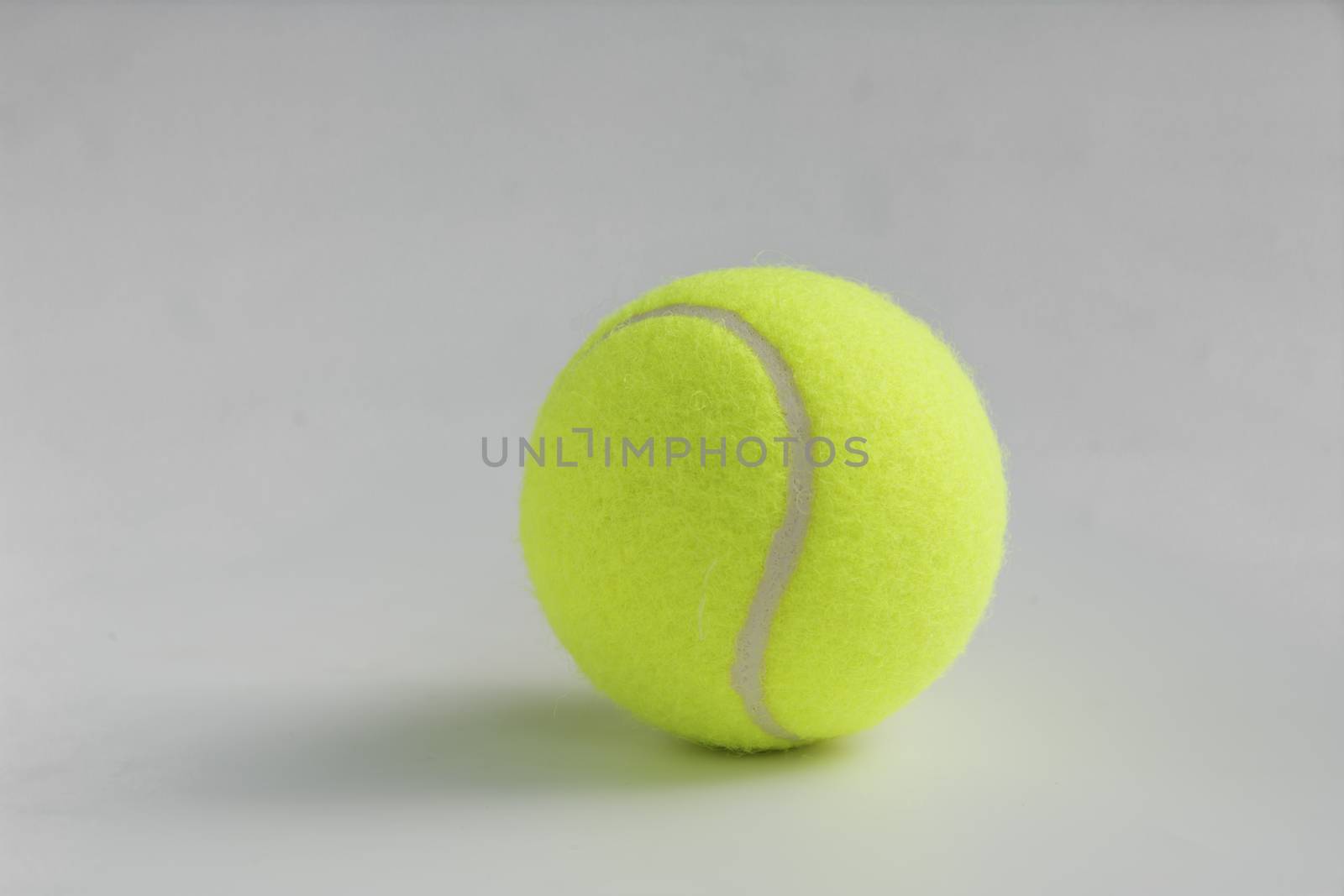 Single yellow tennis ball on the background close up by kirisa99